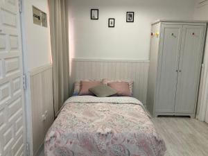 a small bedroom with a bed and a cabinet at 2-Estudio Zona Chamberí Quevedo in Madrid