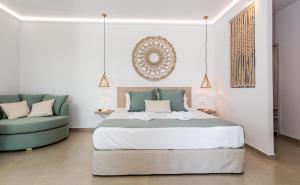 a bedroom with a large bed and a green couch at Terra Oliva Milos in Pollonia