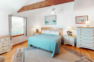 a bedroom with a bed and a dresser and a window at Serenity #294-F in Frisco