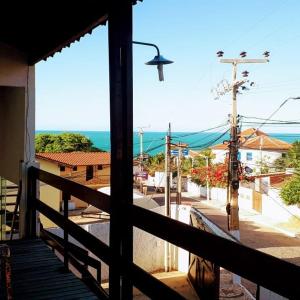 a balcony with a view of a street and the ocean at Pousada Brisa da Canoa in Canoa Quebrada