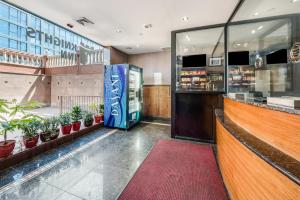 a restaurant with potted plants and a counter at Knights Inn Brooklyn Sunset Park in Brooklyn