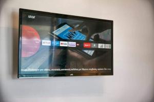 a flat screen tv hanging on a wall at Joanna Apartments in Haraki