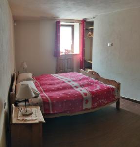 - une chambre avec un grand lit et une couverture rouge dans l'établissement CASA VACANZE CLO 3 CAMERE 2 BAGNI, à Aoste