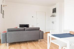 a living room with a couch and a table at Appartamento nuovo da Lilly con terrazza tra centro e mare in Fano +28 photos