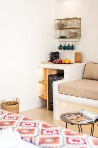 a living room with a couch and a table at Anastasia's Visage Stylish Accommodation Rooms City Centre Mykonos in Mikonos