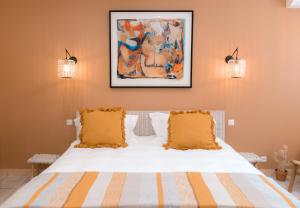 a bedroom with a white bed with two pillows at La Parenthèse de Marie in Tourrettes-sur-Loup +27 photos
