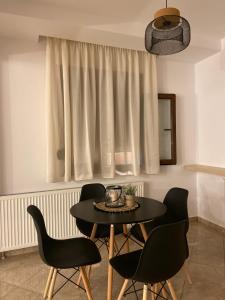 a table and chairs in a room with a window at Summer Dreams Studios in Skala Potamias