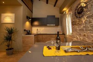 a kitchen with a table with wine glasses on it at ˇDCˇ Modern apartment near the Church in Rovinj