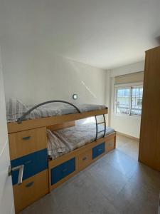 1 dormitorio con litera y cajones azules en Piso a 150 mts de la playa con espectacular terraza y WIFI, en Tossa de Mar