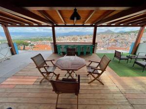 a patio with a table and chairs on a roof at B&B Bella Vista in Dorgali