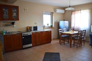 a kitchen with a table and a stove and a refrigerator at Apartment in Gyenesdias - Balaton 18809 in Gyenesdiás +22 photos