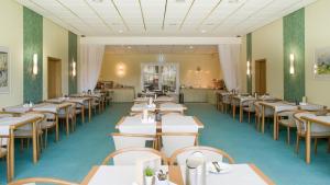 a row of tables and chairs in a restaurant at Saar Galerie in Saarburg
