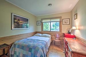 a bedroom with a bed and a desk and a window at Riverfront Retreat about 4 Mi to Downtown Milwaukee! in Glendale +35 photos