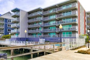 an apartment building on the water with a dock at Assateague House II in Ocean City