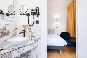 a hotel room with a sink and a bed at Boutique Hotel Nice Côte d'azur in Nice