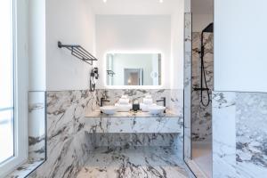 a bathroom with two sinks and a mirror at Boutique Hotel Nice Côte d'azur in Nice