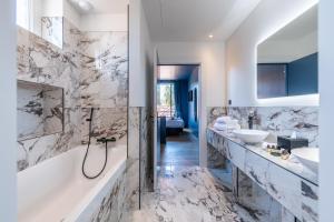 a bathroom with two sinks and a tub and a shower at Boutique Hotel Nice Côte d'azur in Nice