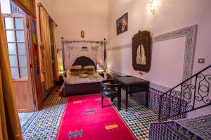 Postel nebo postele na pokoji v ubytování Riad Naila & suite