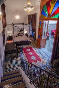a view of a room with a bed and a staircase at Riad Naila & suite in Fès