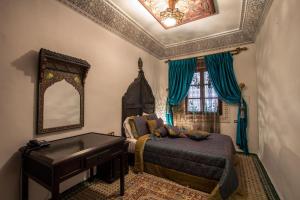 Postel nebo postele na pokoji v ubytování Riad Naila & suite
