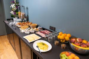 a table with a bunch of food on it at Boutique Hotel Nice Côte d'azur in Nice