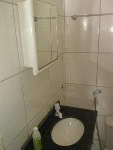 a small bathroom with a sink and a mirror at Pousada & Café da Serra - Pacoti in Pacoti