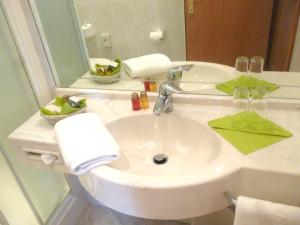 a bathroom with a white sink and a mirror at Hotel Anatol in Merano