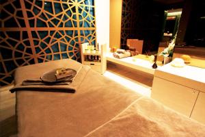 a dressing room with a bed and a mirror at Palmalife Bodrum Resort & Spa in Yalıkavak +203 photos