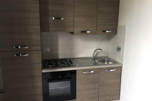 a small kitchen with a stove and a sink at Bologna Central Apartments - Indipendenza 43 in Bologna