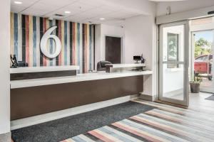 an office with a reception desk and a mirror at Motel 6-Cleburne, TX in Cleburne