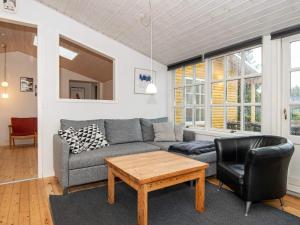 a living room with a couch and a table at 8 person holiday home in R m in Kongsmark