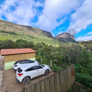 a white car parked in front of a building at Green Chales - Vale do Capão in Vale do Capao
