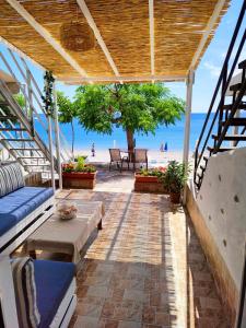 a patio with a view of the beach at Sea Sound Haraki apartment in Haraki