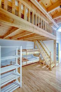 a loft bed in a room with two bunk beds at Les Cremades in Langogne