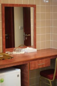 a bathroom with a wooden counter with a mirror at Africana Hotel in Dubai