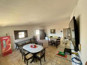 un salon avec une table et quelques chaises dans l'établissement Casa de praia em Cotovelo, à Parnamirim