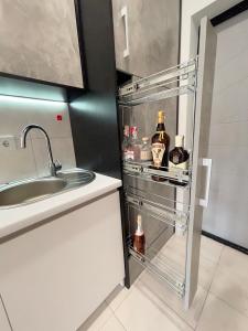 a kitchen with a refrigerator with bottles of alcohol in it at Апартаменты в Аркадии - Arcadia Sky Apartments in Odesa