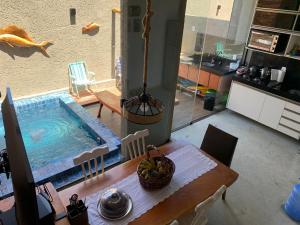 a swimming pool in the middle of a living room at Vila dos Milagres Casa de Charme in São Miguel dos Milagres