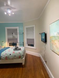 a bedroom with a bed and a flat screen tv at shared house in Federal Hill in Providence