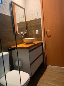 a bathroom with a bowl sink and a toilet at Vila dos Milagres Casa de Charme in São Miguel dos Milagres +12 photos