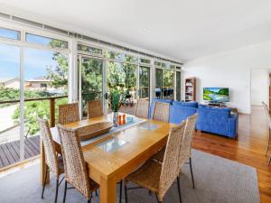 a dining room with a table and chairs at Lewis Retreat 40 Lewis Road in Carrickalinga