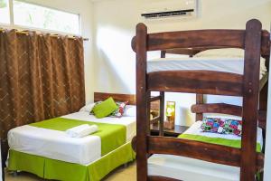 a bedroom with two bunk beds and a window at Eco del Mar in La Libertad