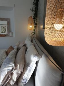 a bedroom with a couch with pillows and a lamp at Aretousa Deluxe Downtown Apartment in Skala
