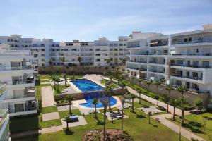 an apartment complex with a courtyard with a swimming pool at Dar Bouazza Luxueux appartement avec vue sur mer in Dar Bouazza