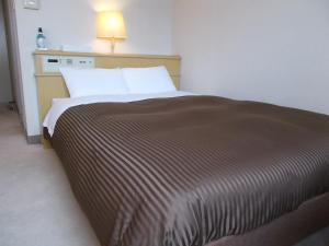 Postel nebo postele na pokoji v ubytování Oyama Palace Hotel