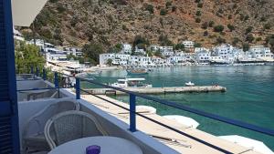 a view from the balcony of a boat in a harbor at Sifis in Loutro