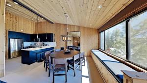 a kitchen and dining room with a wooden ceiling at Beautifully remodeled 3 Bedroom Condo in Mammoth Lakes