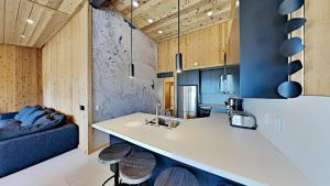 a kitchen with a sink and a couch in a room at Beautifully remodeled 3 Bedroom Condo in Mammoth Lakes