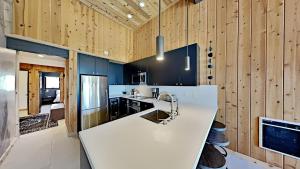 a kitchen with a white counter and wooden walls at Beautifully remodeled 3 Bedroom Condo in Mammoth Lakes +38 photos
