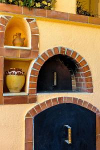 a brick oven with a vase on a wall at Olive Nest, Cozy Apartment in Ammoudara in Ayía Marína